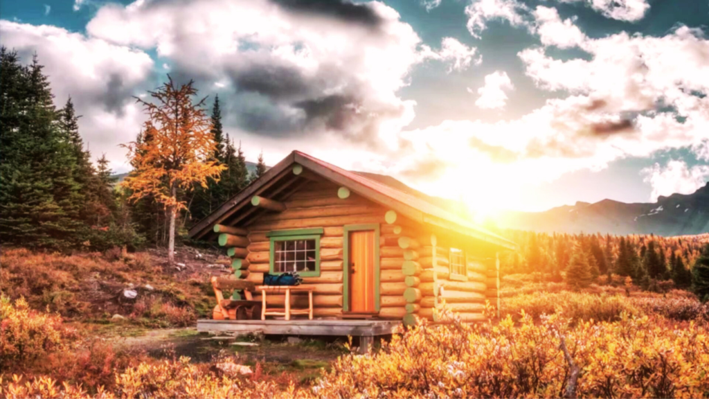 Alberta, Canada - Sep 22 2019 : Sunrise on wooden hut in autumn forest at Assiniboine provincial park, Canada