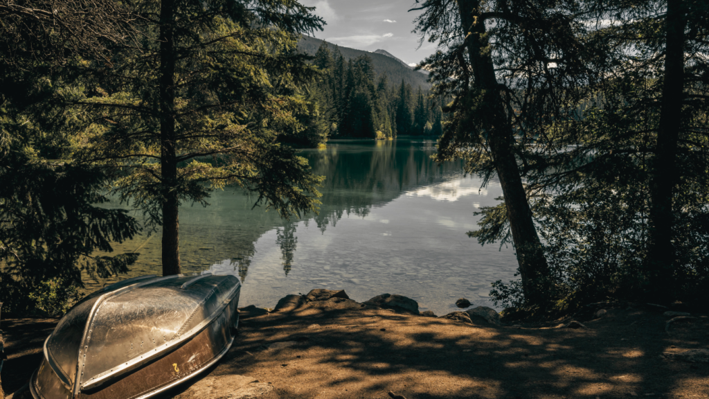 Boat on the lake. The Valley of the Five Lakes hike offers clear lakes with unique shades of jade and blue. Clear water of a mountain lake in Jasper NP