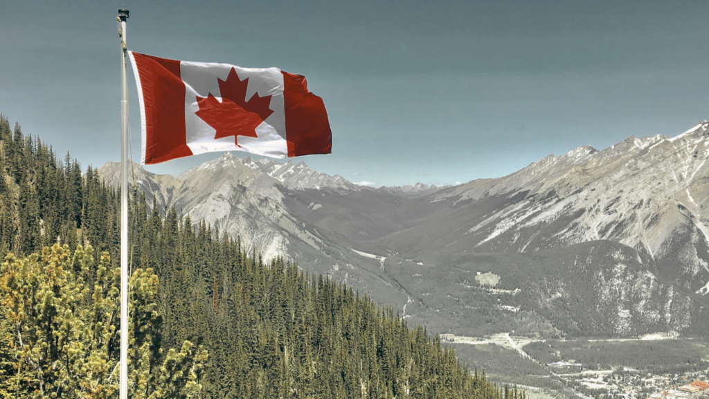 Canada Flag With Mountain Range View